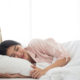 Woman-in-bed-sleeping-on-white-pilloe